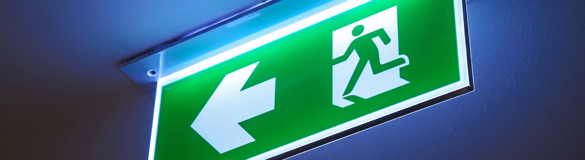 Illuminated emergency exit sign in a commercial building